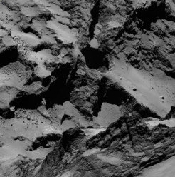 The pits allow for a look up to 200 meters into the comet. The inner walls show layered structures. These pits can be found on the "back" of the comet