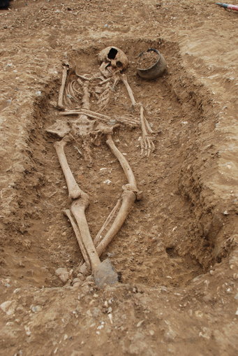 An early Anglo-Saxon grave with pottery vessel, brooches and a Roman Spoon. This grave 66 from Oakington Cambridgeshire contained a woman of mixed ancestry.