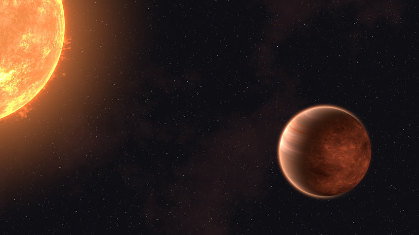 Reddish planet is illuminated in a very narrow orbit by its central star (top left in the image)